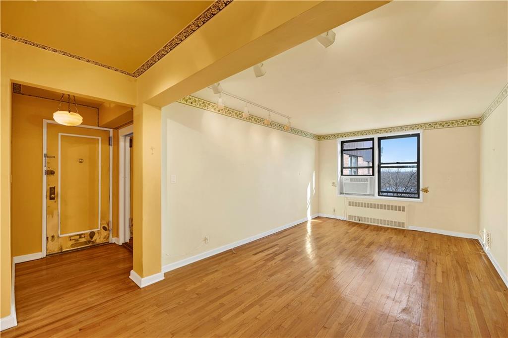 2260 Burnett Street, Unit 6K Brooklyn, NY 11229 - Photo 6 of 17 an empty room with wooden floor and a window