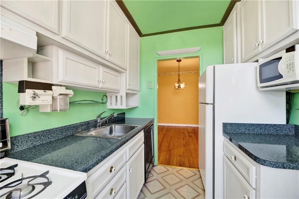 2260 Burnett Street, Unit 6K Brooklyn, NY 11229 - Photo 10 of 17 a kitchen with stainless steel appliances granite countertop a sink stove and refrigerator