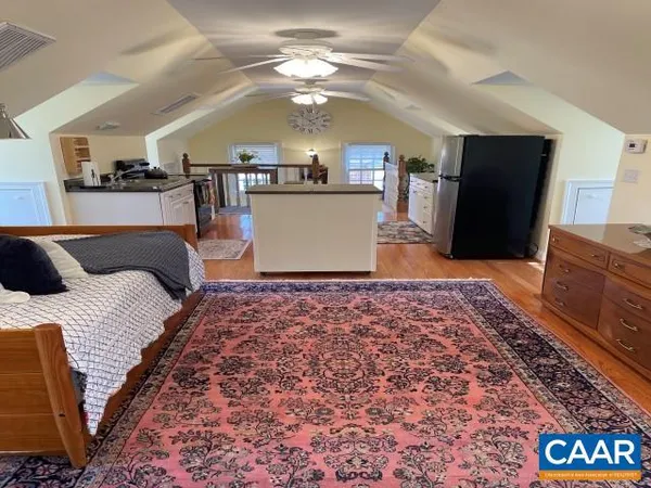 a bed room with a bed furniture and a flat screen tv