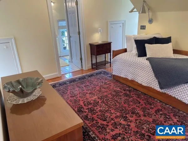 a bedroom with a bed and a couch
