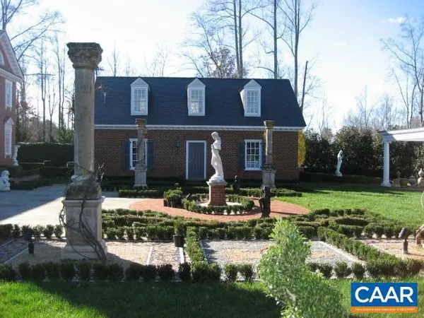 a front view of a house with garden and patio