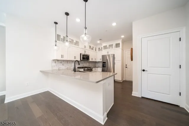 a large kitchen with stainless steel appliances kitchen island a large island in the center