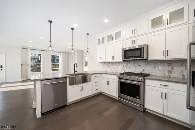 a bathroom with a granite countertop sink mirror vanity and toilet