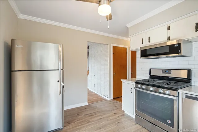a kitchen with stainless steel appliances a refrigerator stove and microwave