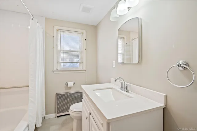 a bathroom with a sink toilet and a mirror
