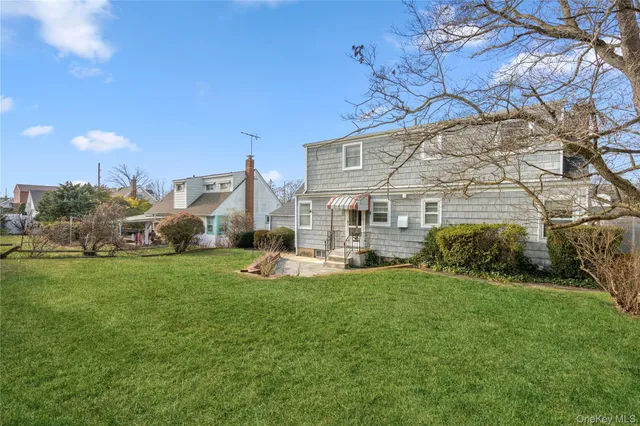 a view of a house with backyard and sitting area