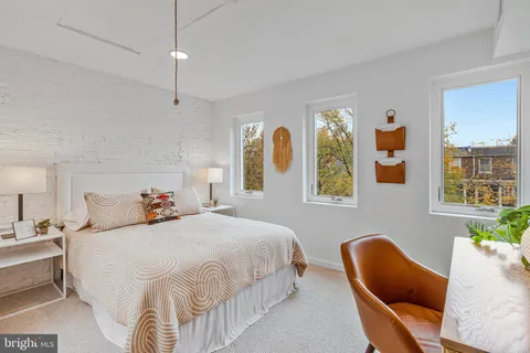 a bedroom with bed and window