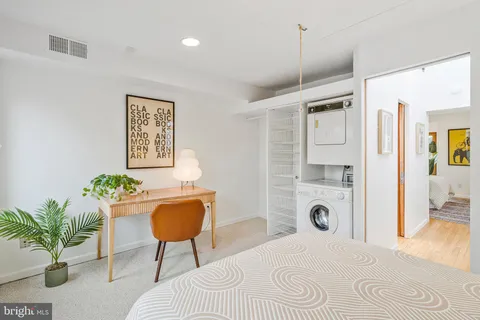 a bedroom with a bed and a potted plant