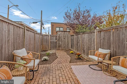 a backyard of a house with table and chairs