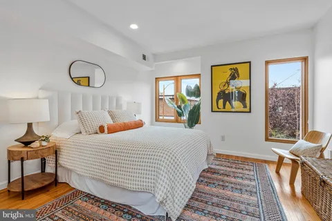 a bedroom with a bed and wooden floor