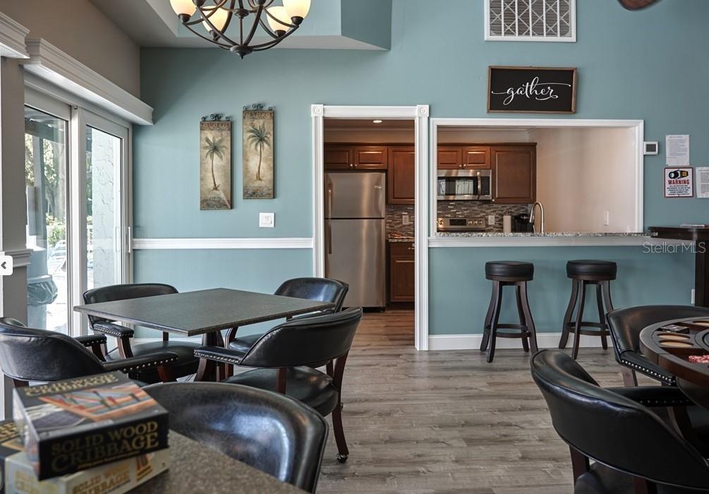 3249 South Beneva Road, Unit 204 Sarasota, FL 34232 - Photo 11 of 44 a view of a dining room with furniture and chandelier