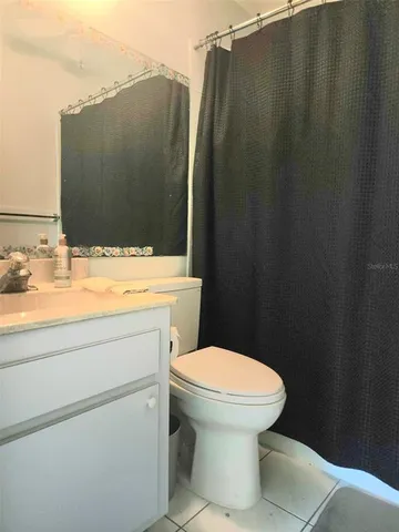 a bathroom with a shower a toilet and a tub