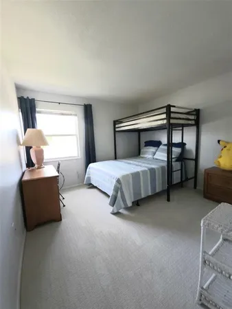 a bedroom with a bed and a potted plant