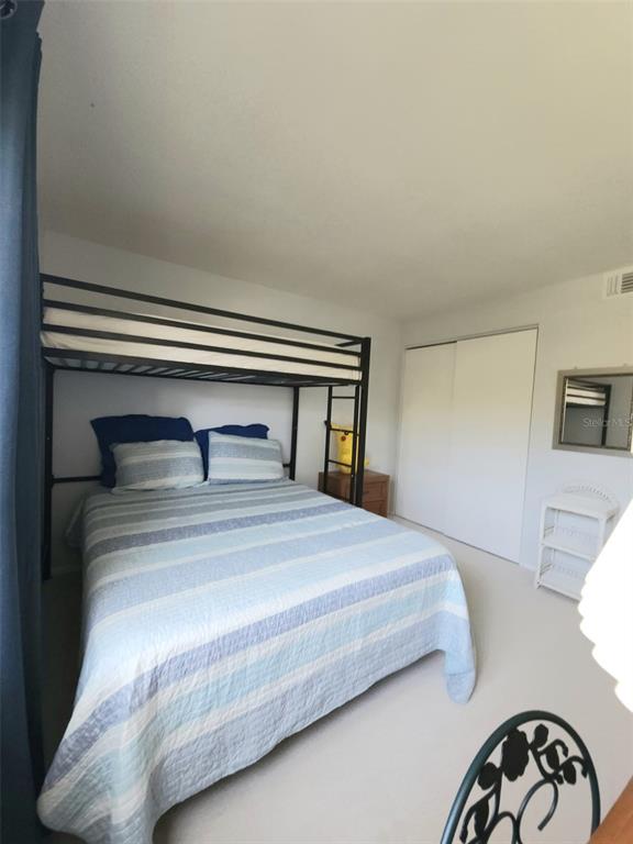 3249 South Beneva Road, Unit 204 Sarasota, FL 34232 - Photo 26 of 44 a bedroom with a bed and a potted plant