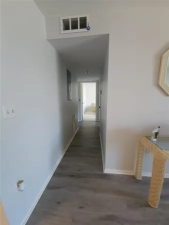 a view of a hallway view of wooden floor