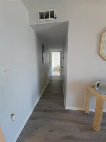 a view of a hallway view of wooden floor
