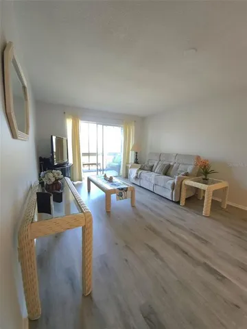 a living room with furniture wooden floor and a table