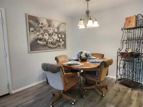 a view of a dining room with furniture wooden floor and a chandelier