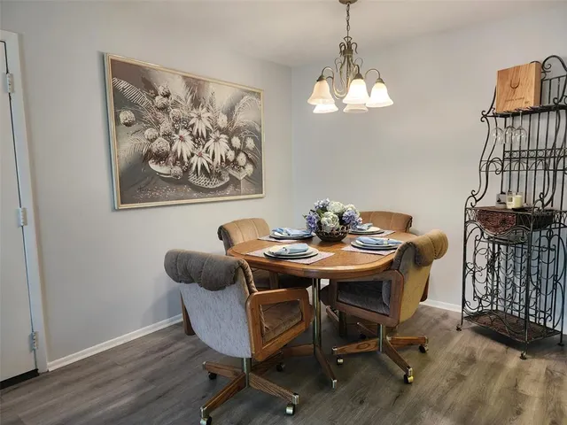 a view of a dining room with furniture wooden floor and a chandelier