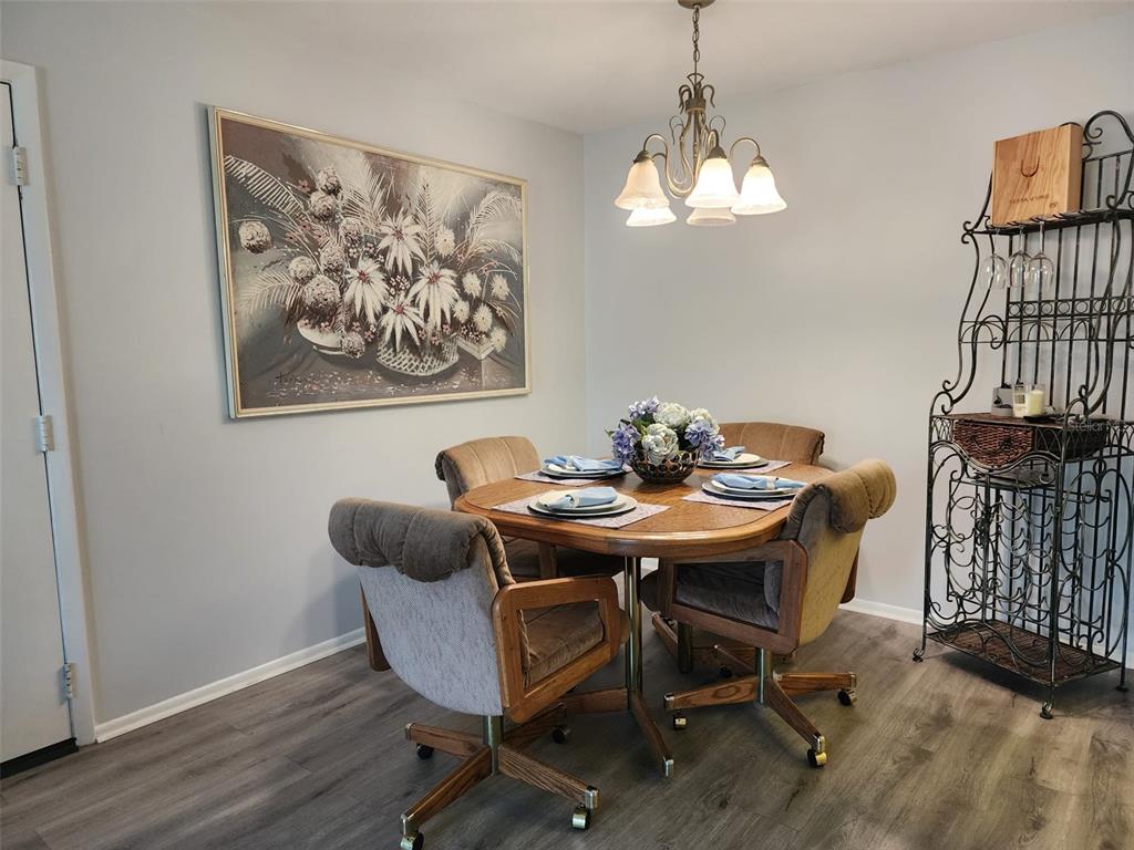 3249 South Beneva Road, Unit 204 Sarasota, FL 34232 - Photo 36 of 44 a view of a dining room with furniture and wooden floor