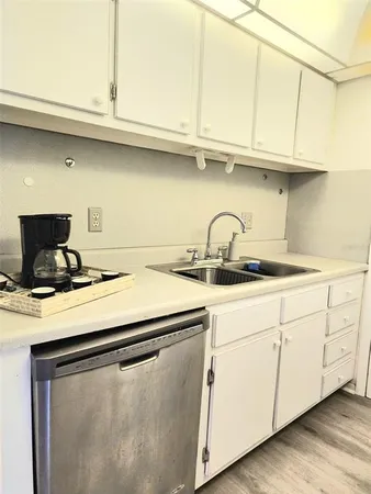 a kitchen with a sink and cabinets