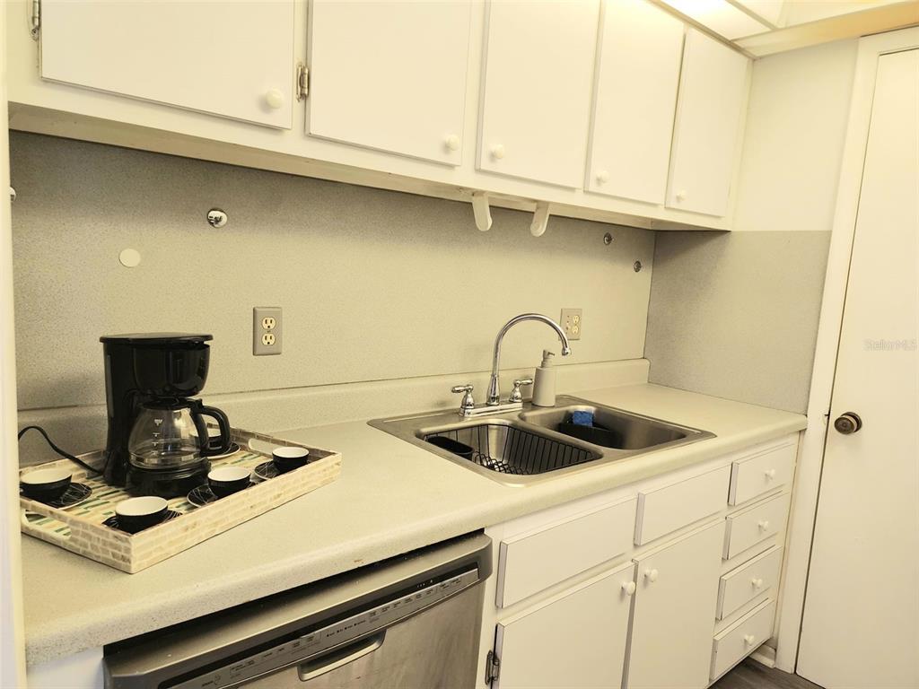 3249 South Beneva Road, Unit 204 Sarasota, FL 34232 - Photo 40 of 44 a kitchen with a sink and cabinets