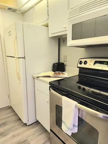 a stove top oven sitting inside of a kitchen