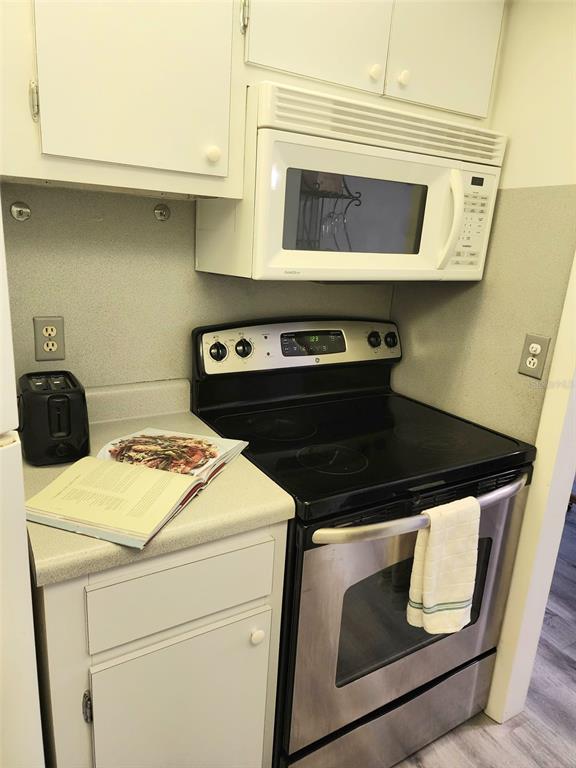 3249 South Beneva Road, Unit 204 Sarasota, FL 34232 - Photo 42 of 44 a stove top oven sitting inside of a kitchen
