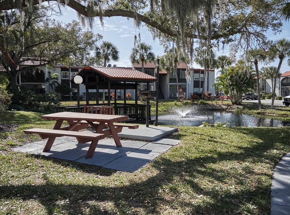 3249 South Beneva Road, Unit 204 Sarasota, FL 34232 - Photo 5 of 44 a swimming pool with outdoor seating and yard