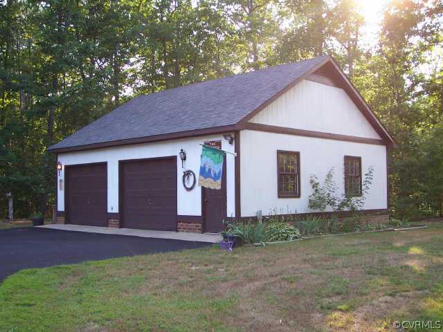 12518 2nd Branch Road Chesterfield, VA 23838 - Photo 6 of 8 a front view of a house with a yard and garage