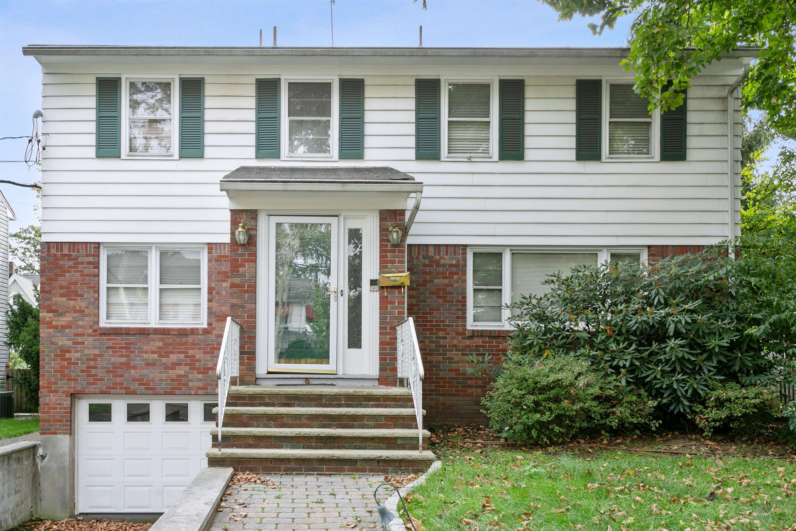 39 Raymond Avenue Rutherford, NJ 07070 - Photo 1 of 15 a front view of a house with a yard