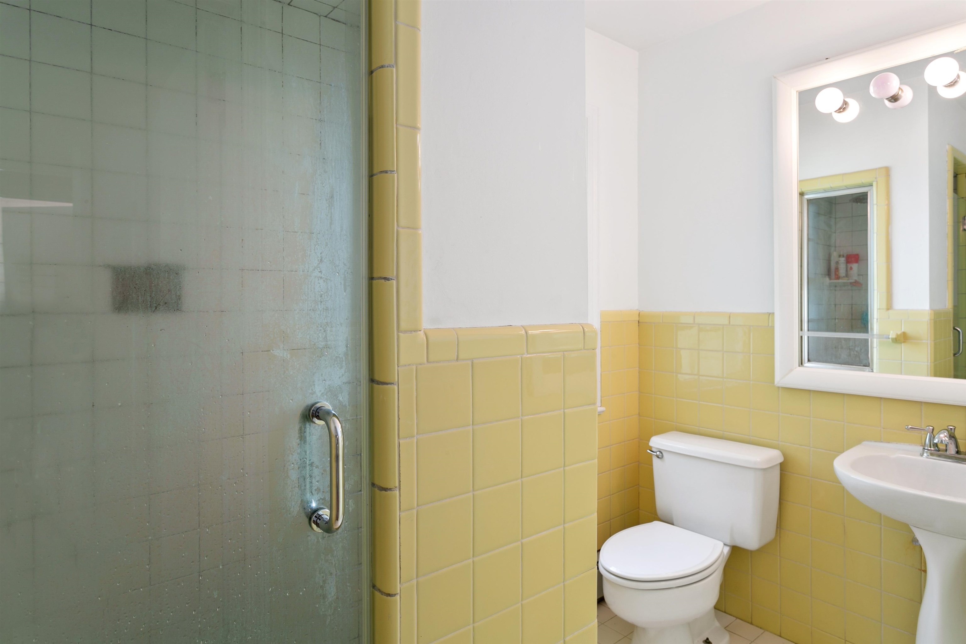 39 Raymond Avenue Rutherford, NJ 07070 - Photo 11 of 15 a white toilet sitting next to a bathroom sink