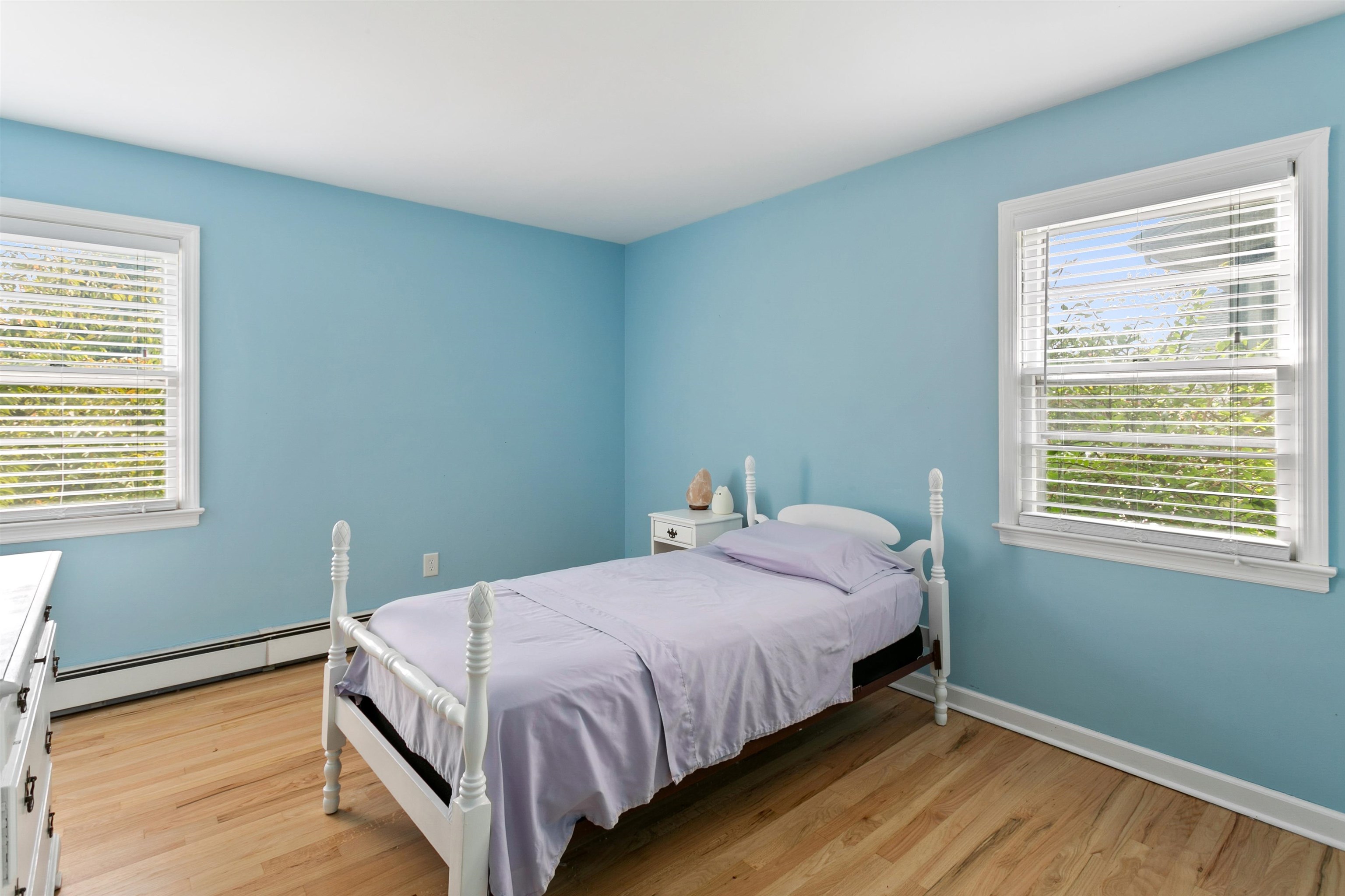 39 Raymond Avenue Rutherford, NJ 07070 - Photo 12 of 15 a bed sitting in a bedroom next to a window