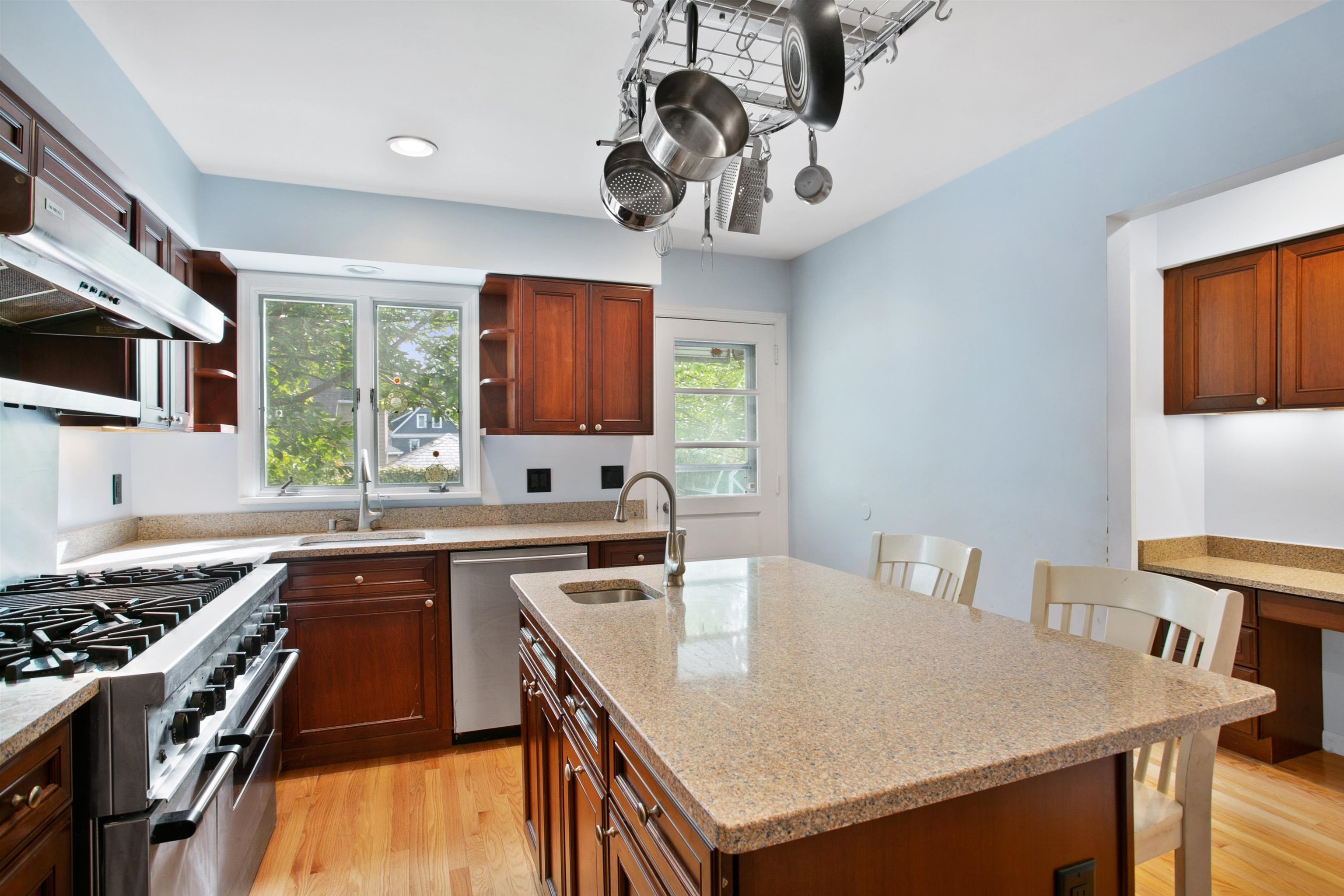 39 Raymond Avenue Rutherford, NJ 07070 - Photo 5 of 15 a kitchen with stainless steel appliances granite countertop a sink a stove a microwave cabinets and a dining table