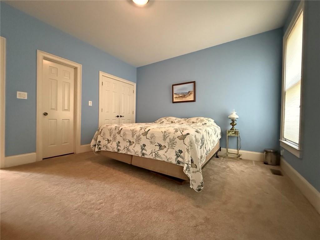 8350 Jacobs Ridge Lane Cumming, GA 30028 - Photo 13 of 68 a bedroom with a bed and a window