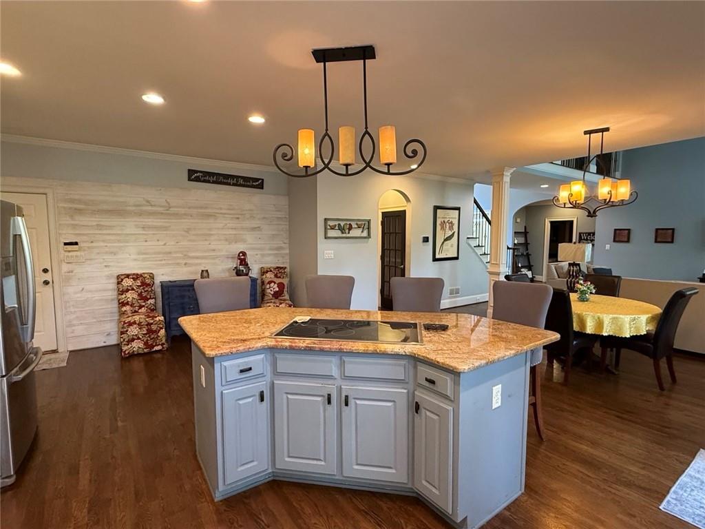 8350 Jacobs Ridge Lane Cumming, GA 30028 - Photo 19 of 68 a kitchen with stainless steel appliances granite countertop a sink a stove and a wooden floors