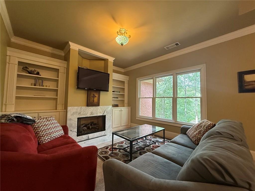 8350 Jacobs Ridge Lane Cumming, GA 30028 - Photo 22 of 68 a living room with fireplace furniture and a flat screen tv