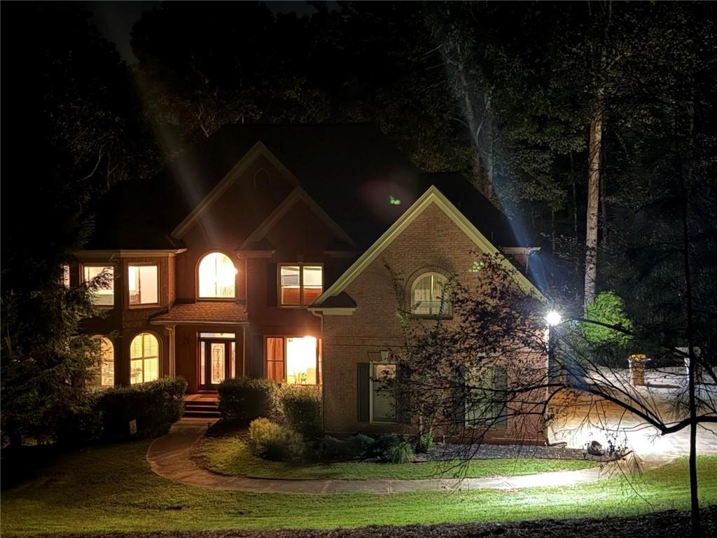8350 Jacobs Ridge Lane Cumming, GA 30028 - Photo 3 of 68 a front view of a house with garden