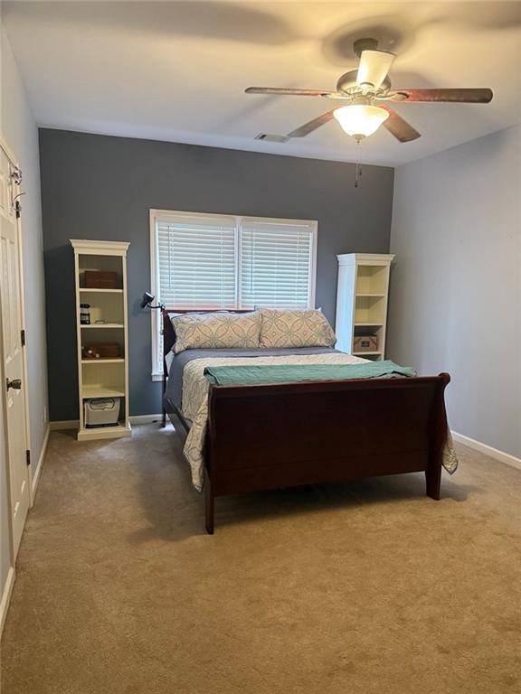 8350 Jacobs Ridge Lane Cumming, GA 30028 - Photo 31 of 68 a bedroom with a bed and a chandelier