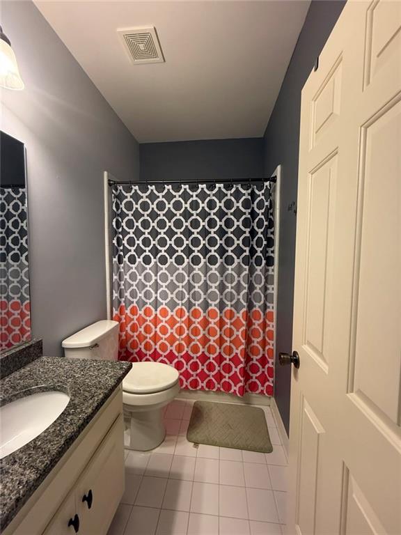 8350 Jacobs Ridge Lane Cumming, GA 30028 - Photo 32 of 68 a bathroom with a granite countertop toilet a sink and a shower curtain