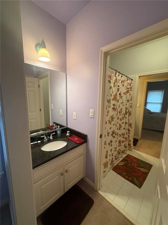 8350 Jacobs Ridge Lane Cumming, GA 30028 - Photo 35 of 68 a bathroom with a sink a mirror and a shower