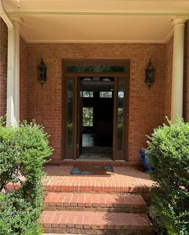 a view of a living room filled with furniture and wooden floor
