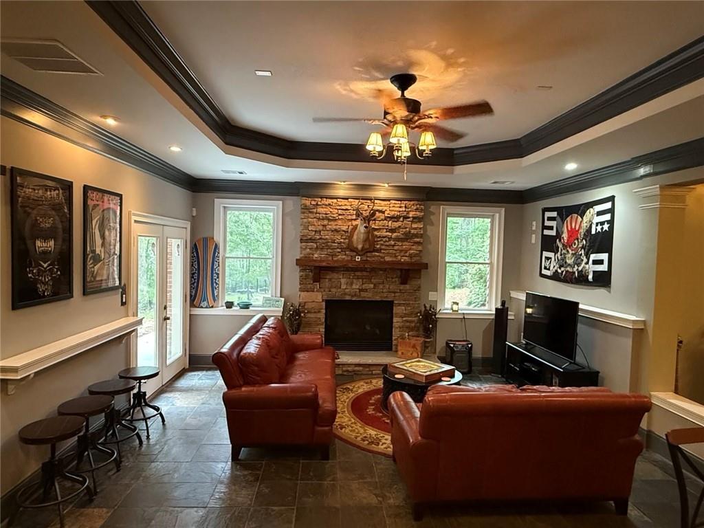 8350 Jacobs Ridge Lane Cumming, GA 30028 - Photo 42 of 68 a living room with furniture a fireplace and a flat screen tv