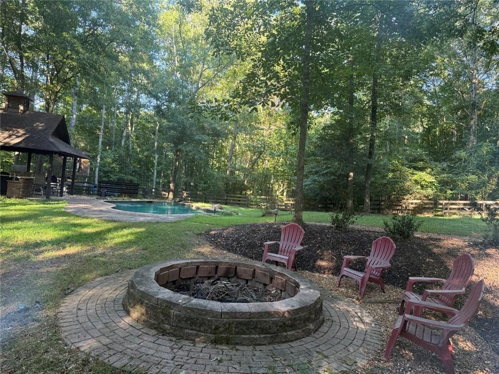 8350 Jacobs Ridge Lane Cumming, GA 30028 - Photo 63 of 68 a view of a backyard with table and chairs potted plants and large tree