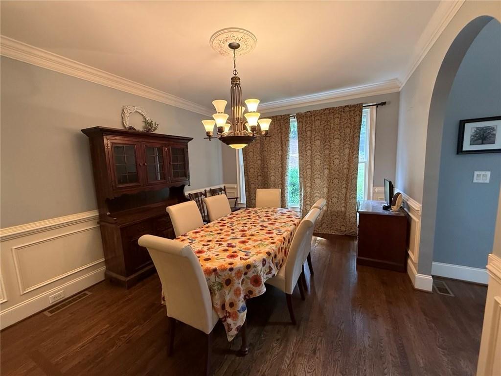 8350 Jacobs Ridge Lane Cumming, GA 30028 - Photo 7 of 68 a dining room with furniture a chandelier and wooden floor