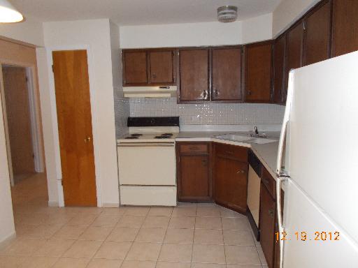 850 South Lorraine Road, Unit 2K Wheaton, IL 60189 - Photo 3 of 9 a kitchen with a stove sink and a refrigerator