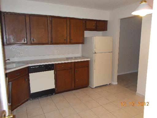 850 South Lorraine Road, Unit 2K Wheaton, IL 60189 - Photo 4 of 9 a kitchen with a refrigerator sink and cabinets