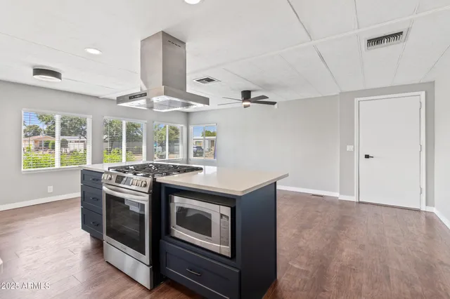 a kitchen with stainless steel appliances granite countertop a stove and a refrigerator