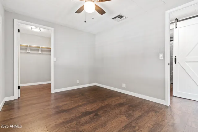 a view of an empty room with wooden floor