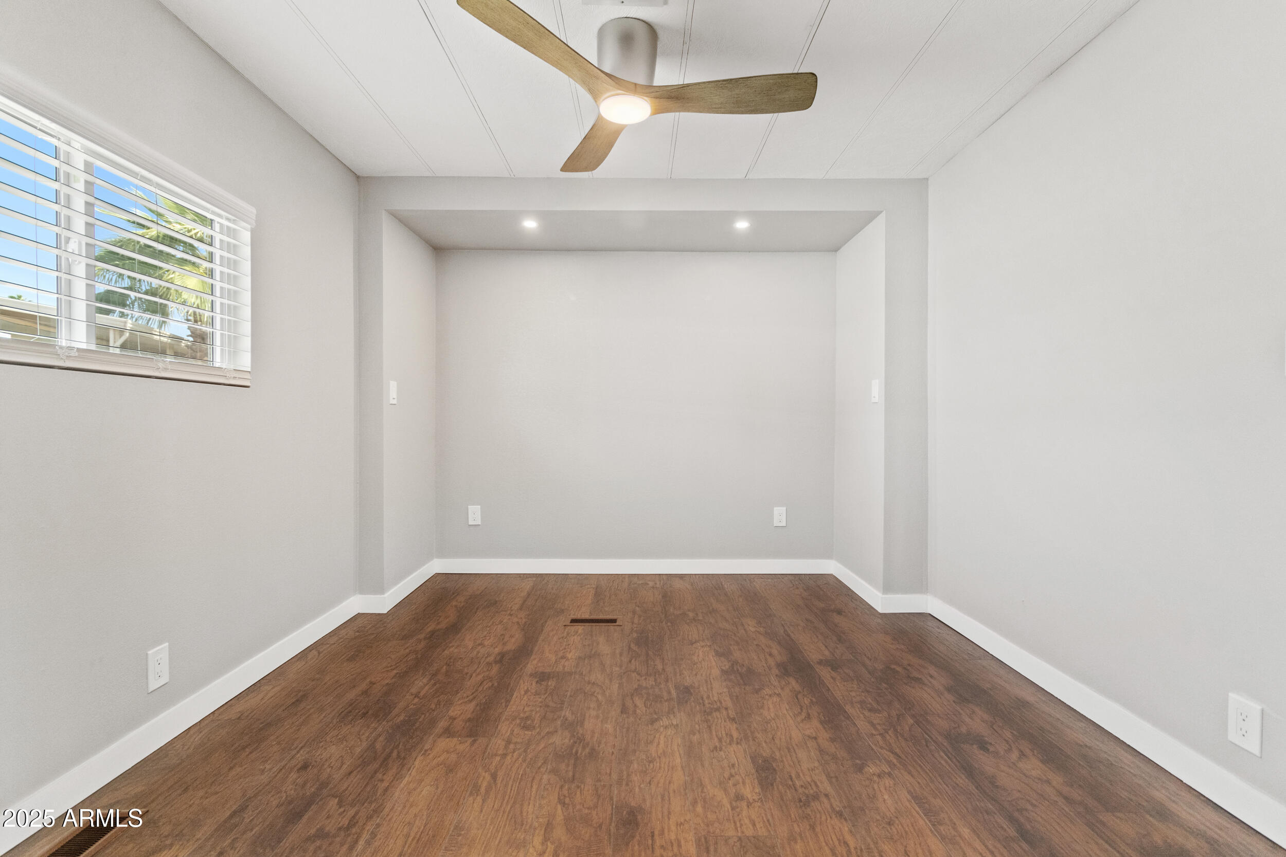 2401 West Southern Avenue, Unit 224 Tempe, AZ 85282 - Photo 24 of 47 an empty room with a window and wooden floor